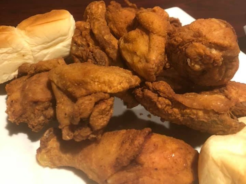 A plate of fried chicken pieces and two dinner rolls. Photo from Neil Street Blues Facebook page.