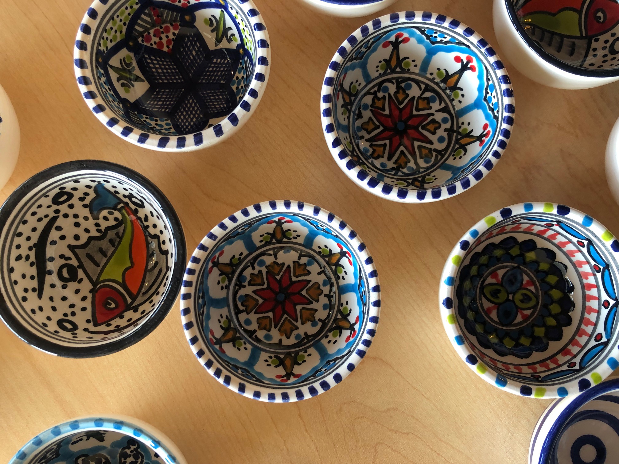 An overhead photo shows the inside of hand-painted bowls. Photo by Alyssa Buckley.