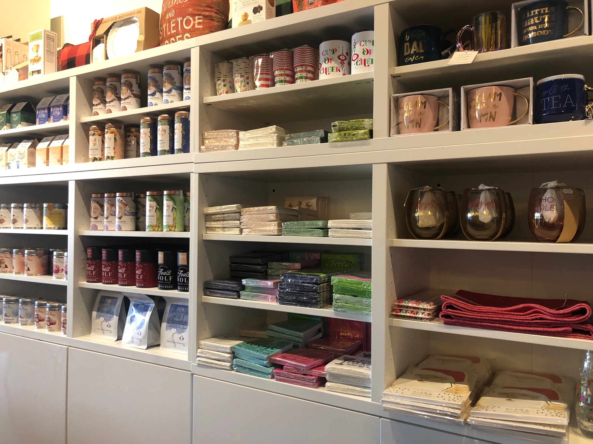 On white shelves, napkins, glasses, and tableware are for sale. Photo by Alyssa Buckley.