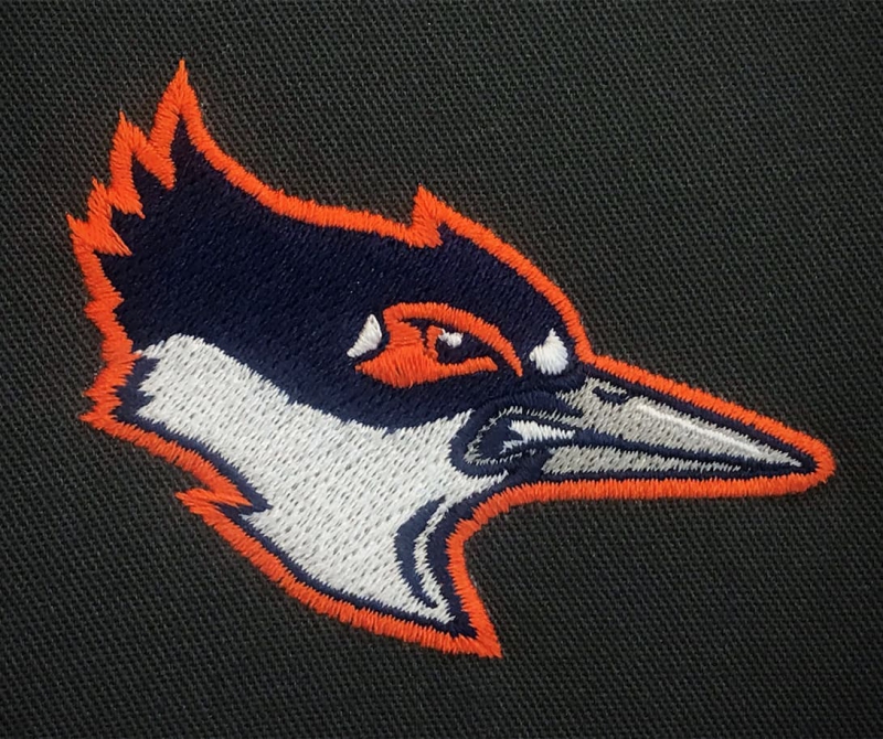 A woven patch of a bird's head. It's blue and white with an orange border, and has a gray beak. Photo from Kingfisher Facebook page.