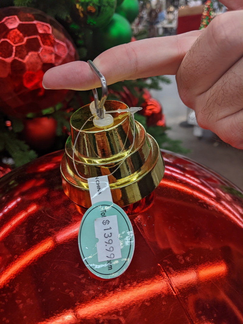 A close up of the price tag hanging at the top of the red ornament. It says #139.99. Photo by Andrea Black. 