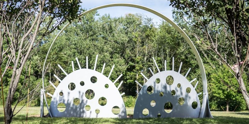 Photo of metal sculpture featuring large circles and gears within them. Photo by Sam Logan. 