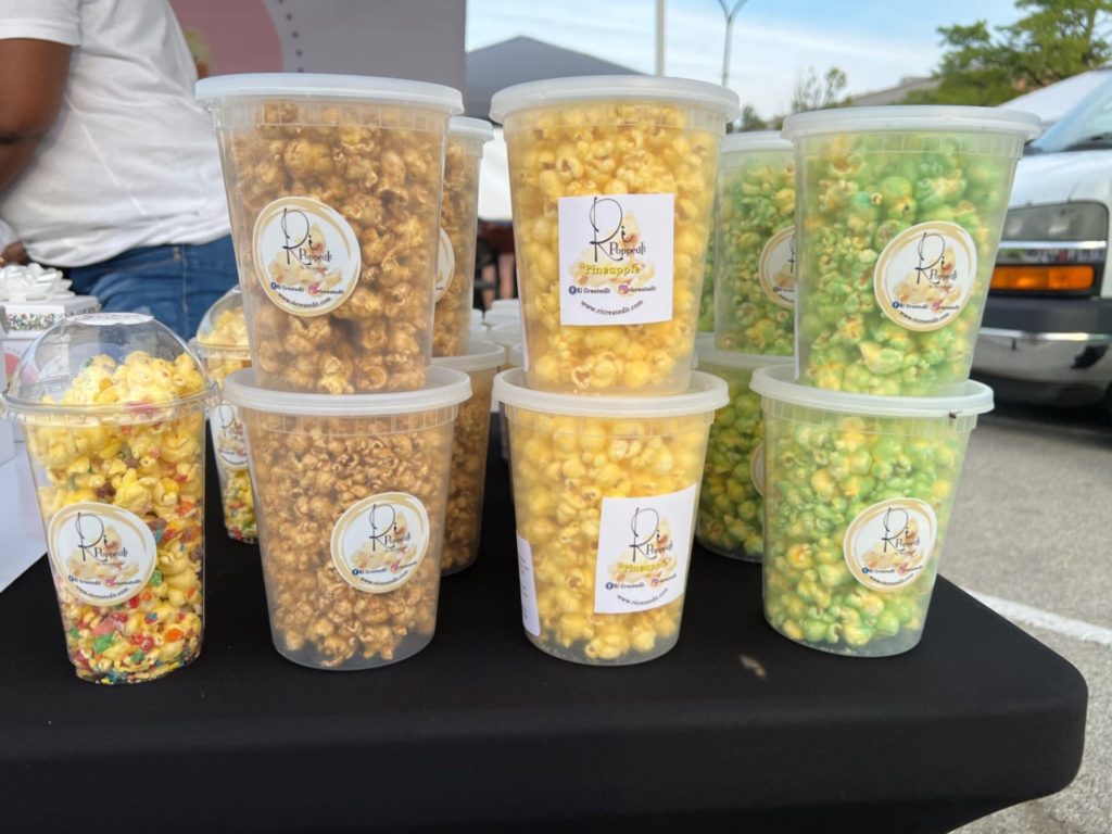 Buckets of popcorn by RiPoppedIt for sale at the market.